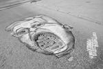 Карикатуры на екатеринбургских чиновников расположили так, что ямы и дорожные ухабы стали частью их портретов&#160;(фото: ИТАР-ТАСС)