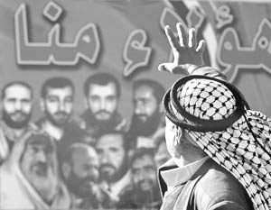 Палестинский избиратель изучает предвыборный плакат группировки Хамас